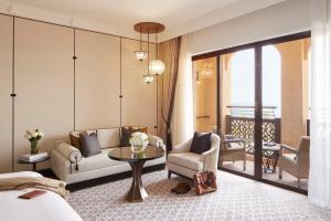a hotel room with a bed and a table and chairs at Jumeirah Mina Al Salam Dubai in Dubai +37 photos