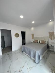 Posteľ alebo postele v izbe v ubytovaní Apartamento Casa Blanca