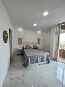 Posteľ alebo postele v izbe v ubytovaní Apartamento Casa Blanca