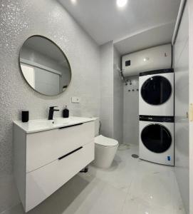a bathroom with a sink and a toilet and a mirror at Apartamento Casa Blanca in Las Palmas de Gran Canaria