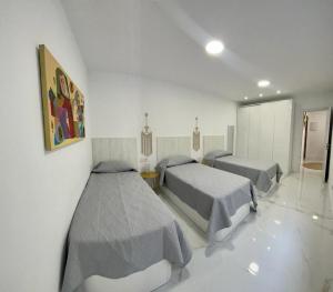 Posteľ alebo postele v izbe v ubytovaní Apartamento Casa Blanca