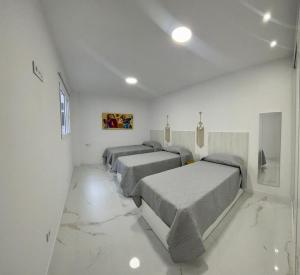 Posteľ alebo postele v izbe v ubytovaní Apartamento Casa Blanca