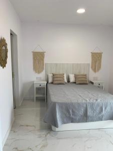 Posteľ alebo postele v izbe v ubytovaní Apartamento Casa Blanca