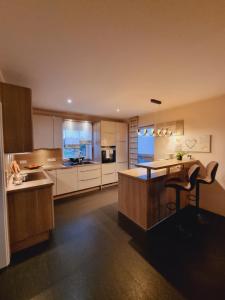 a large kitchen with a table and a chair in it at Haus Moor Merland in Moormerland