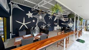 a dining room with stars painted on the wall at La Posada Jungle Hotel in Manuel Antonio