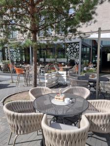 a patio with a table and chairs with a cake on it at Grimm's Potsdamer Platz in Berlin