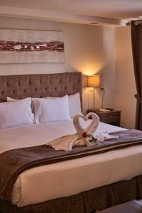 Una habitación de hotel con una cama con cisnes. en Casona Plaza Hotel Arequipa, en Arequipa