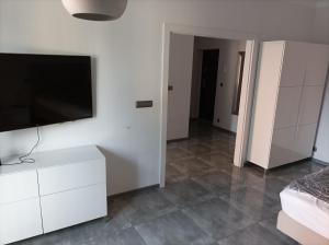 a living room with a tv on a white wall at Przy Katedrze in Koszalin