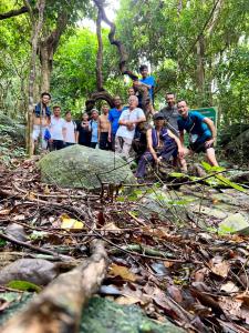 a group of people posing for a picture in the woods at Homestay De la Rosa - Côn Đảo in Con Dao