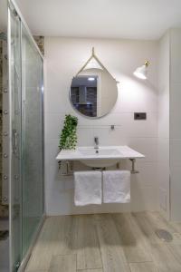 y baño con lavabo y espejo. en Acogedor Loft Bazán - Alicante Centro en Alicante