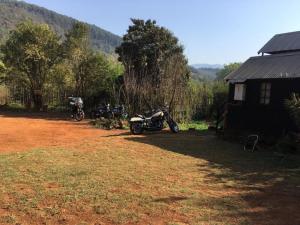 a group of motorcycles parked next to a house at Sabie Gypsy's Backpackers in Sabie