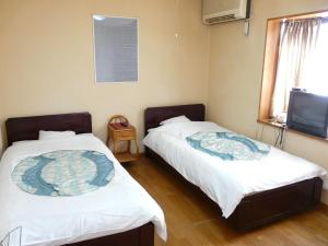 Postel nebo postele na pokoji v ubytování Shinwaka Lodge