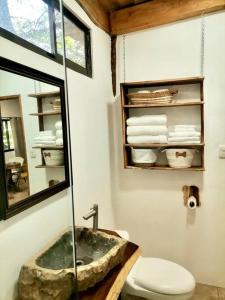 a bathroom with a sink and a toilet and a mirror at A Nature Lovers Paradise! - Iona Villas in Sámara