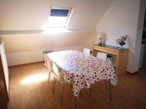a dining room table with a polka dot table cloth at Appartement Chaleureux in Albert