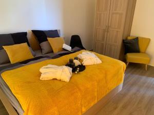 a teddy bear laying on top of a bed at eifel24, neues und modernes Appartement mit Dachterrasse in Schwirzheim