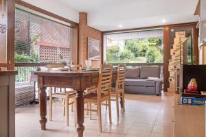 a dining room with a wooden table and chairs at A due passi dal lago in Laveno-Mombello