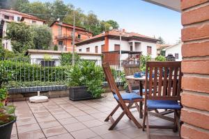 a patio with two chairs and a table on a balcony at A due passi dal lago in Laveno-Mombello