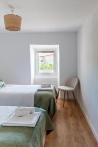 Postel nebo postele na pokoji v ubytování Casa das Rosas - Roses House