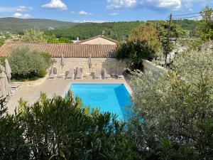 an external view of a villa with a swimming pool at Hotel Berneron in Vallon-Pont-dʼArc