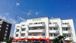 a white building with a flag on top of it at Cumberland Hotel - OCEANA COLLECTION in Bournemouth