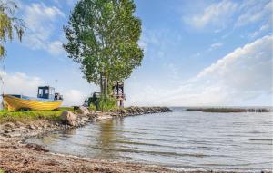 a boat on the shore of a body of water at 2 Bedroom Lovely Apartment In Wolin in Wolin
