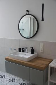 a bathroom with a white sink and a mirror at Altstadtvilla in Borkum
