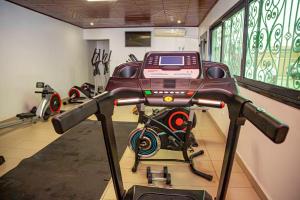 a room with a gym with a bike on a treadmill at ORION RESIDENCY BONABERIE in Douala