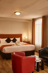 Tempat tidur dalam kamar di Casona Plaza Hotel Colonial