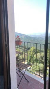 a balcony with a bench and a view at “Sa Scala” Bed&Terrace in Baunei