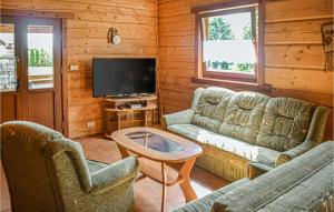 a living room with two couches and a tv at 2 Bedroom Nice Home In Mscice in Mścice