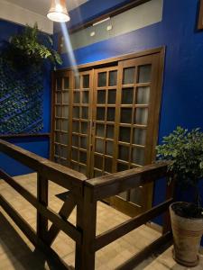 a wine cellar with a wooden bench and a blue wall at Pousada Luar do Prata in Trindade