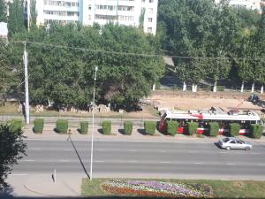 a parking lot with a bus on a street at 2х комнатные апартаменты VIP на Назарбаева 44 in Pavlodar