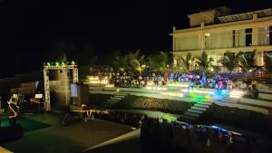 een groep mensen die 's nachts buiten een gebouw staan bij juSTa Rudra Resort & Spa in Kolad