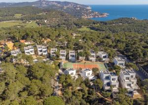 an aerial view of a house with a tennis court at 4 Bedroom Modern House, Llafranc, Costa Brava in Llafranc