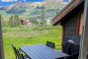 a table and chairs on a porch with a view of a mountain at Northstar 13 in Telluride