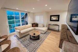 a living room with a couch and a table at Northstar 13 in Telluride