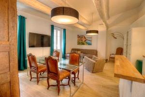 a dining room and living room with a table and chairs at Les Remparts Antibes Location in Antibes