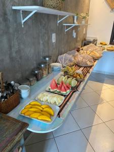 a buffet with many different types of food on a table at Pousada Luar do Prata in Trindade