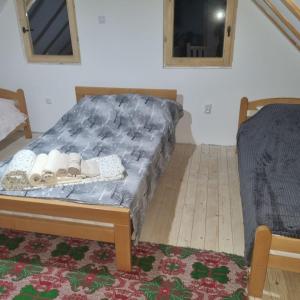 a bedroom with a bed with shoes on it at Vikendica Jovicic in Kraljevo