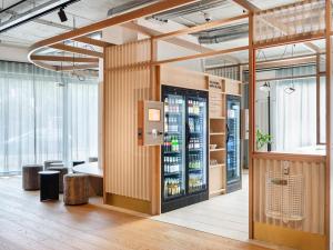 a drink station in a room with a drink cooler at STAYERY Frankfurt Sachsenhausen in Frankfurt/Main