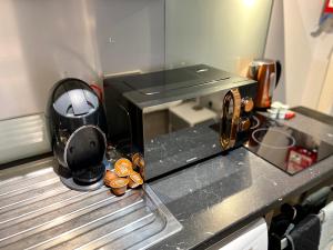 a kitchen with a coffee maker on a counter at Cute and cosy studio in a Fantastic Location! BISHOPS STORTFORD in Bishops Stortford