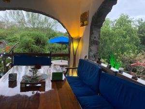 a living room with a blue couch and a table at La Fortaleza De Haro in Puerto Ayora
