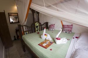 a bedroom with two beds with flowers on it at Zenji Hotel in Zanzibar City