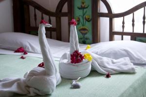two towel animals sitting on top of a bed at Zenji Hotel in Zanzibar City