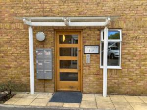 a brick building with a door and a window at Roomspace Serviced Apartments - Lomond Court in Surbiton