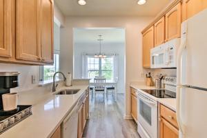 a kitchen with wooden cabinets and white appliances at Gorgeous Lewes Getaway about 3 Mi to the Beach! in Lewes