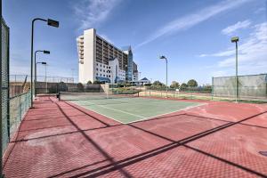 a tennis court in front of a building at Shop & Dine: Fort Worth Condo w/ Racetrack Views! in Fort Worth