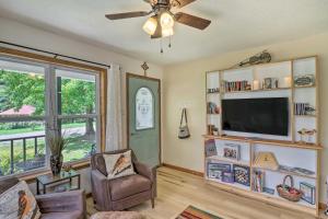 a living room with a ceiling fan and a television at Mountain View Home Steps to Amphitheater Park in Mountain View