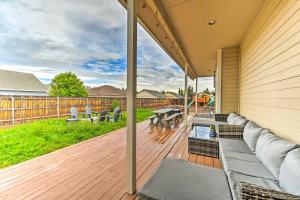 a patio with a couch and chairs on a wooden deck at Classy Bellemont Home with Hot Tub and Playground in Bellemont