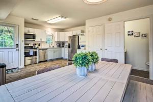 a kitchen with a wooden table with two plants on it at Historic Dtwn Home 2 Mi to Military Park! in Gettysburg